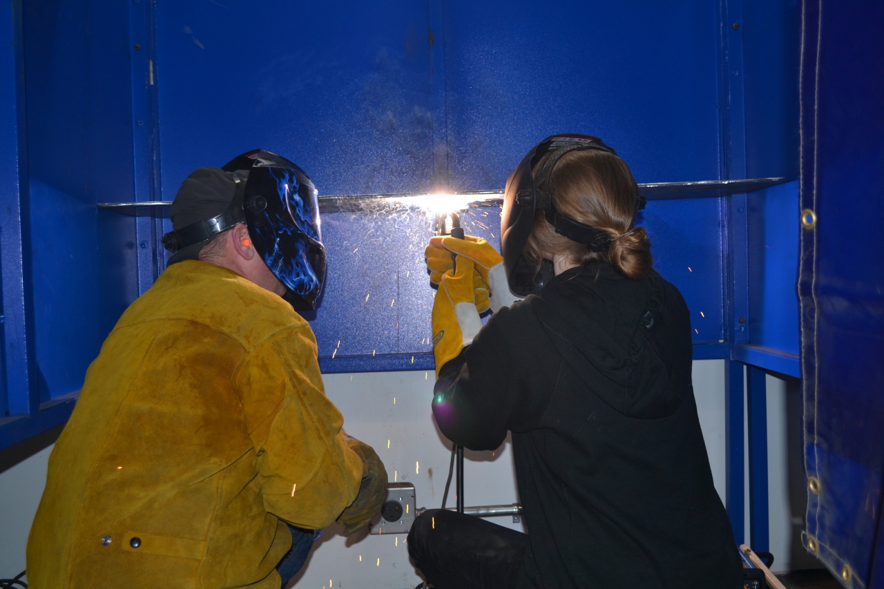 instructor and student welding